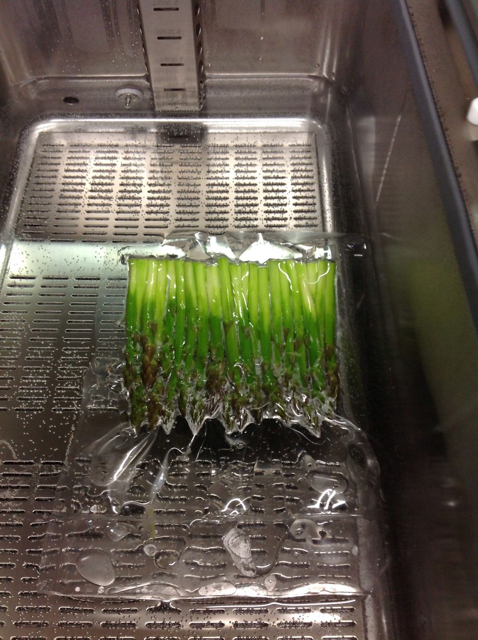 Once your eggs are done, carefully remove from bath and increase temp to 160F. Then add sealed Asparagus.