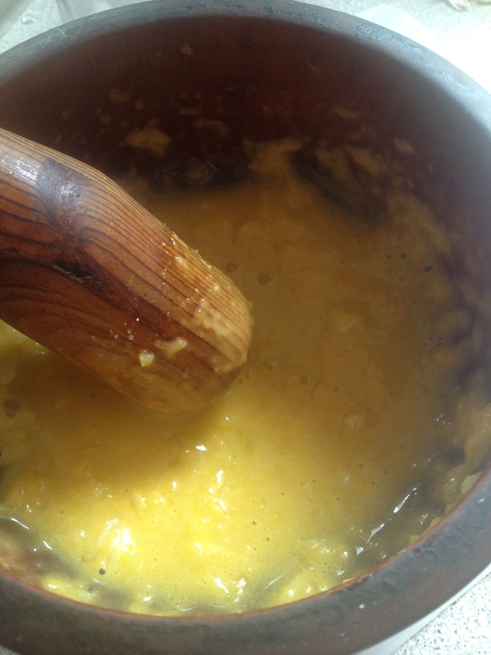 Once your hand hurts and you made sure you grinded most of the garlic, add one more egg yolk and more olive oil... Keep grinding.