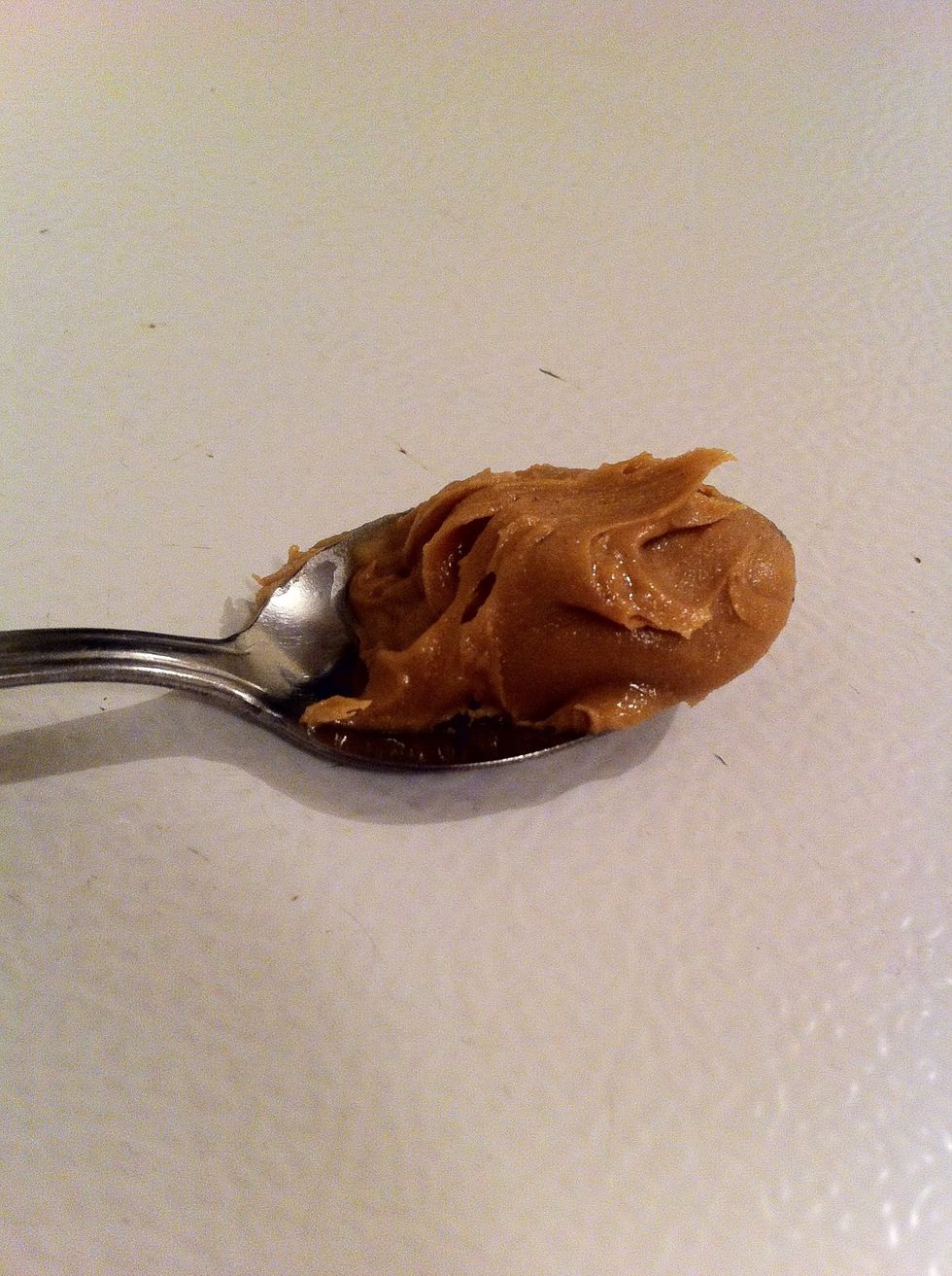 Once your milk has started getting warm, drop about 3/4 teaspoon of peanut butter into the milk. Stir until it melts into the milk