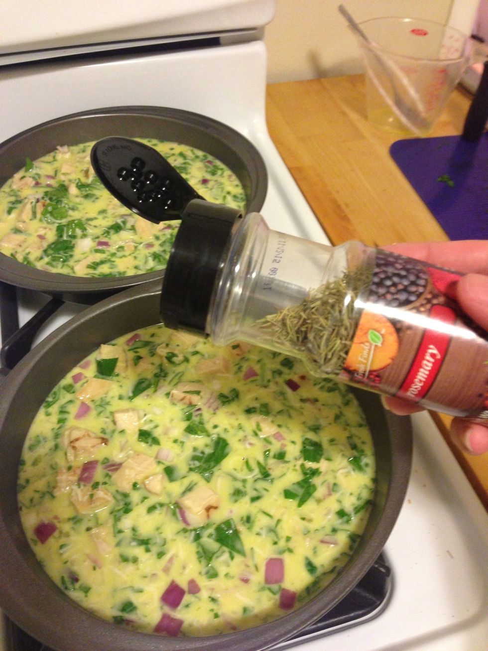 Once your mixture is all finished mixing, pour it into the pans. Garnish with 2 tsp of rosemary between the two quiche.