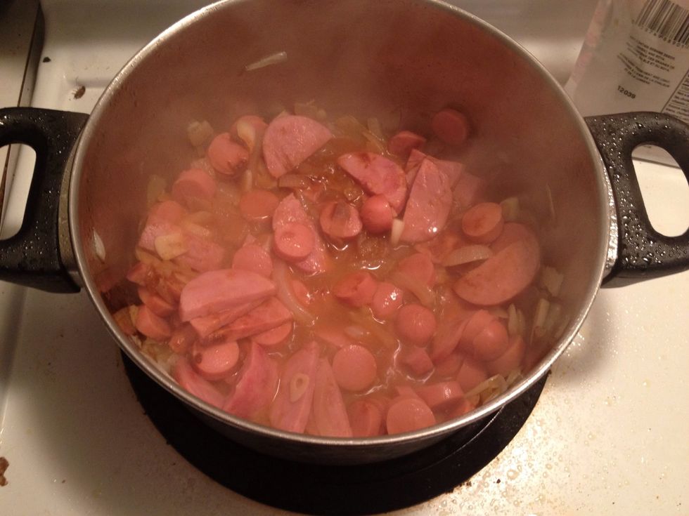 Once your onions are the color like on the previous picture add the SAUSAGES, HOTDOGS, GARLIC & the POWDER (no potatoes, tomato yet) the powder how much... Really up to you I usually cook by my taste
