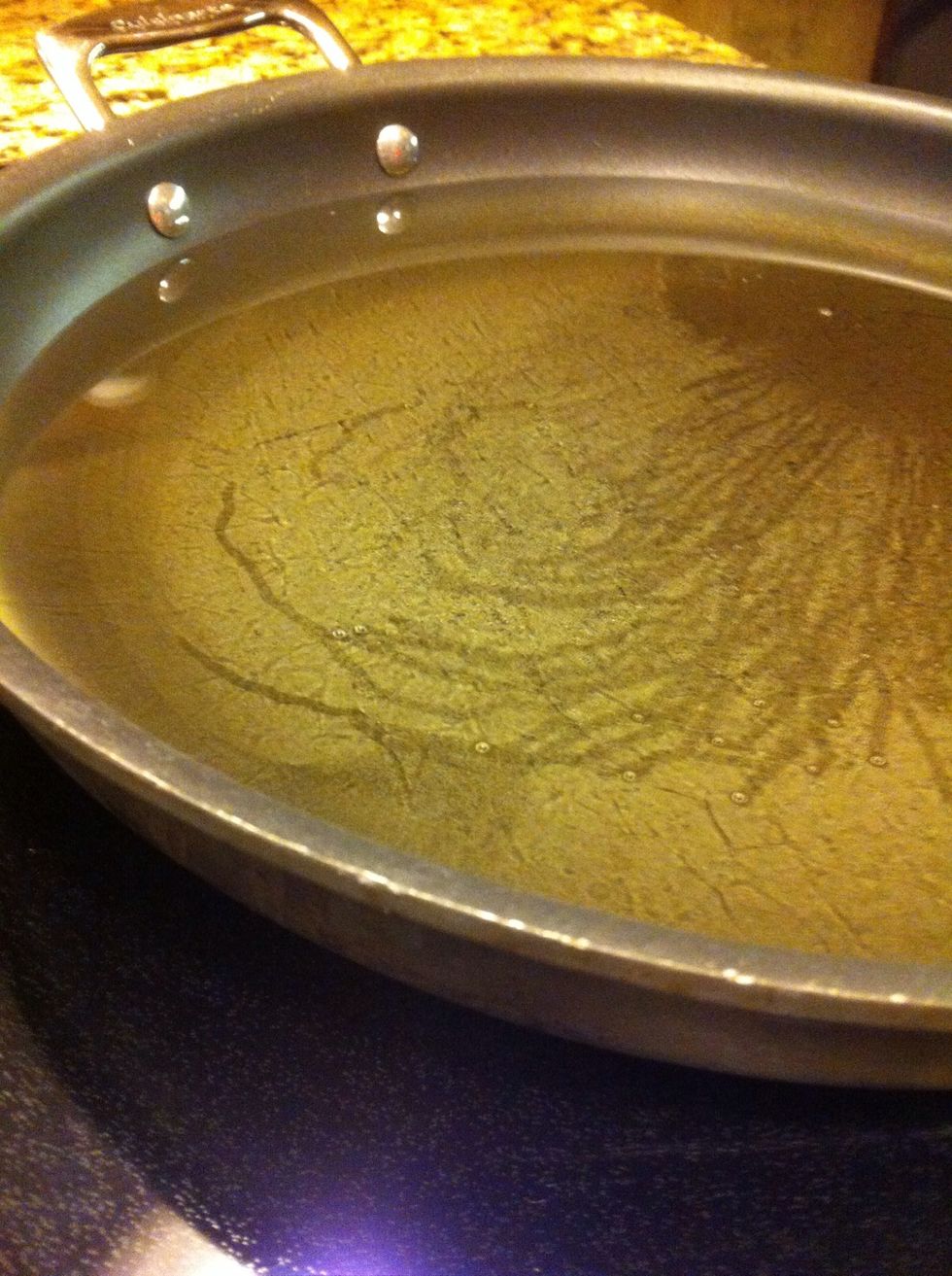 Once your pan is smoking hot, add peanut oil. As you can see, I added a little more than half way up the pan