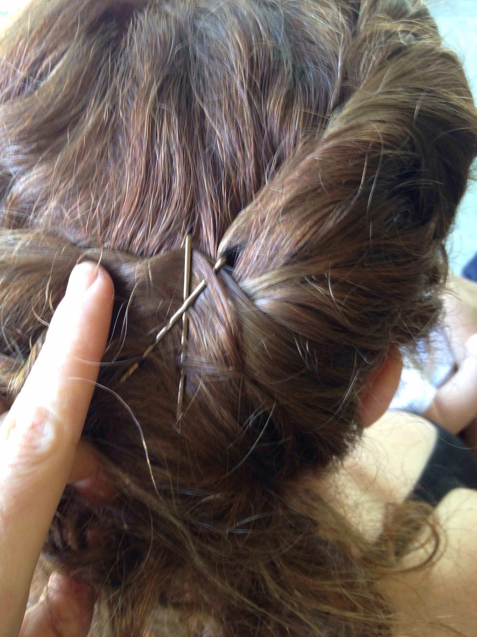 Once your twist has reached behind your ear, and includes all hair from your front hair and temple area, pin it securely with criss-cross bobby pins.