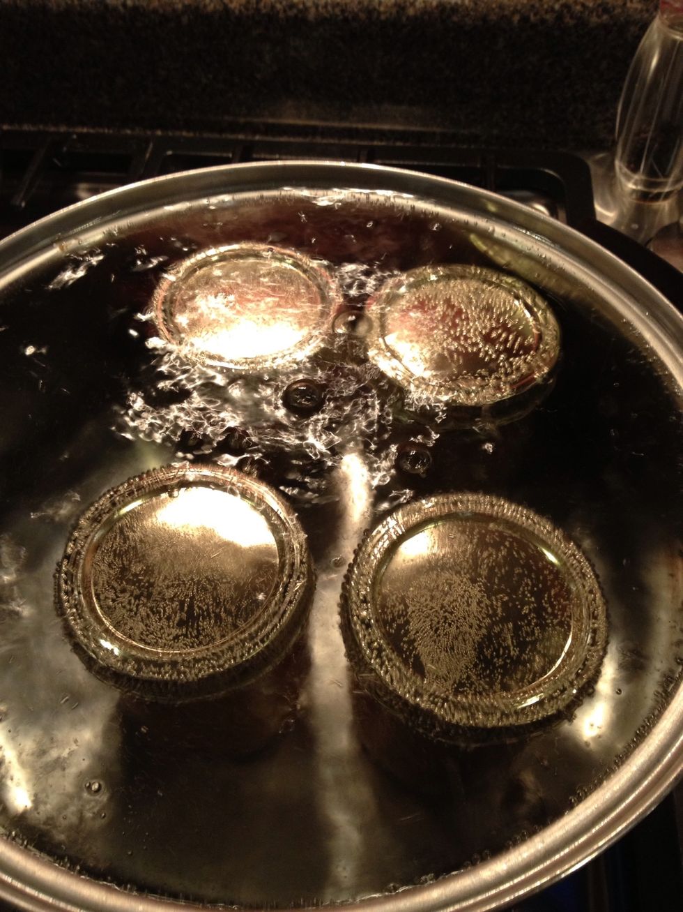 Once your water is boiling, place your closed jars in the boiling water. Your jars should be completely submerged and covered by at least 1 inch of water.
