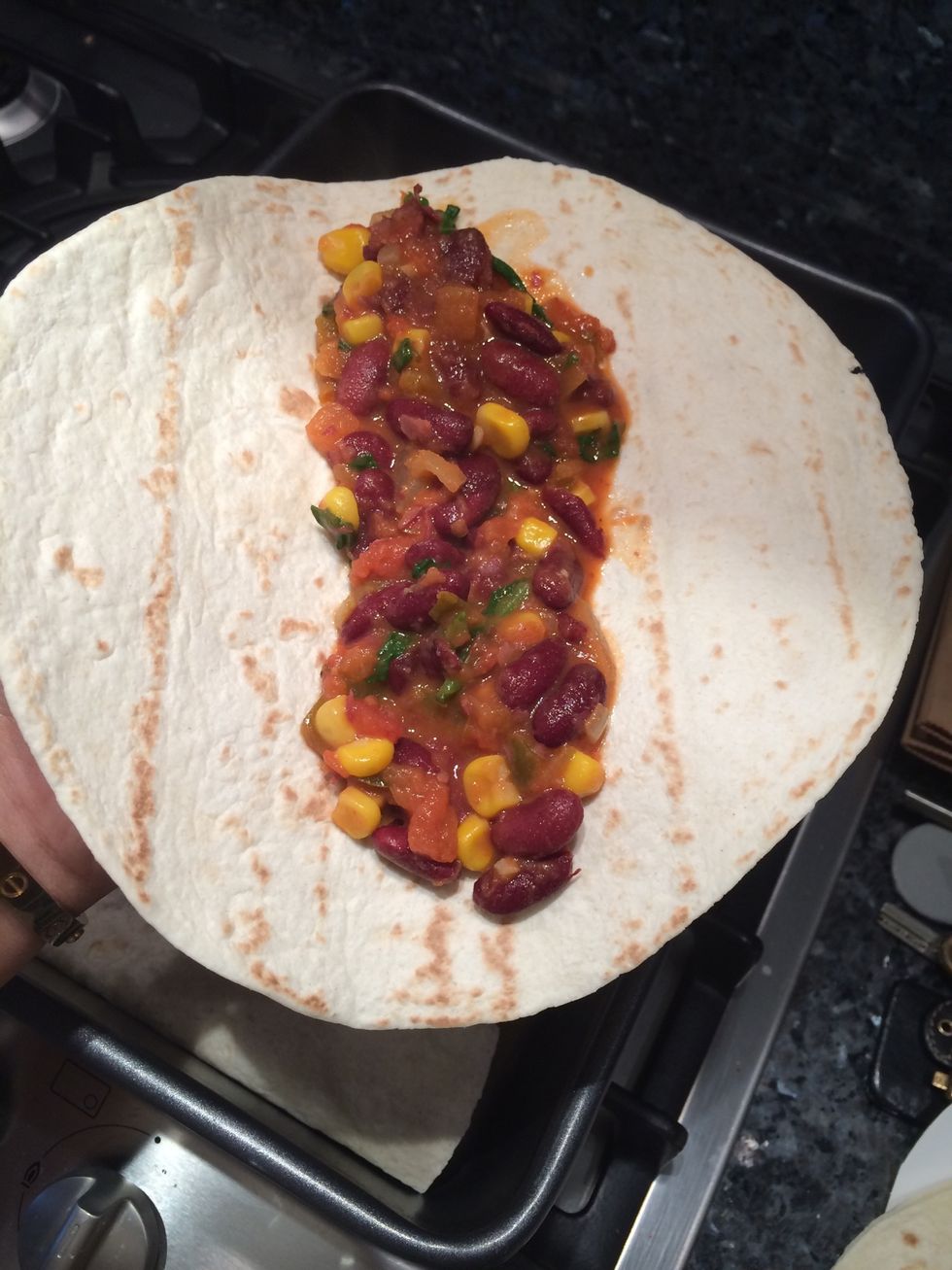 One all mixed together and simmered add the mixture into the wrap and roll and put in baking tin or any other oven safe tin.