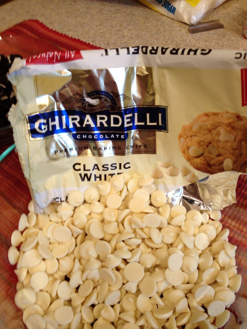 One bag of white chocolate chips. There is no added flavoring so if you don't have chips you are willing to eat alone, you can add a small amount of vanilla at the very end - 1/2 teaspoon.