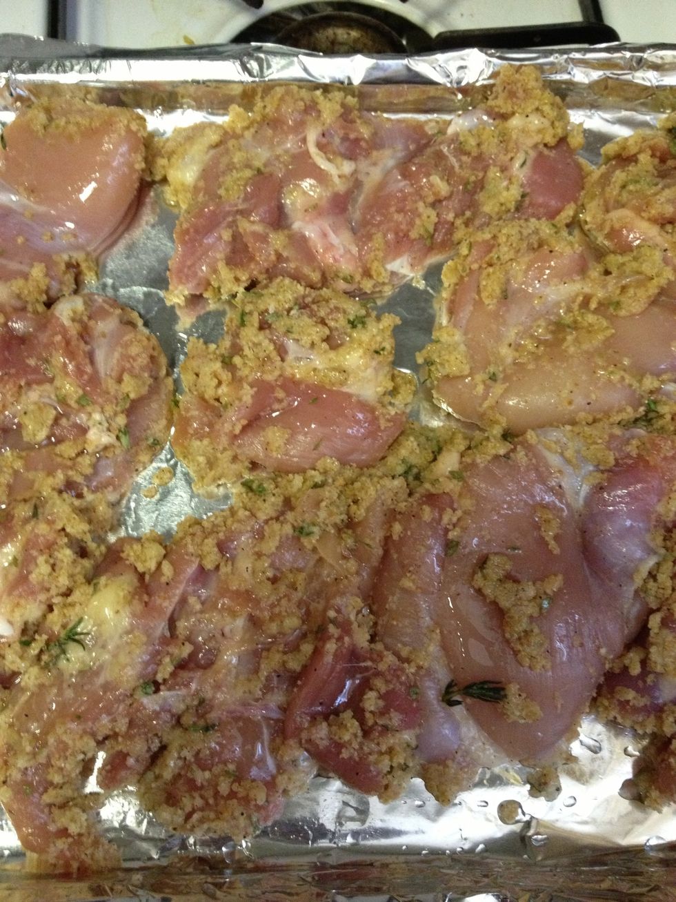 One-by-one, combine chicken with season mix and mix together until all pieces are evenly coated. Place chicken on lightly greased baking pan.