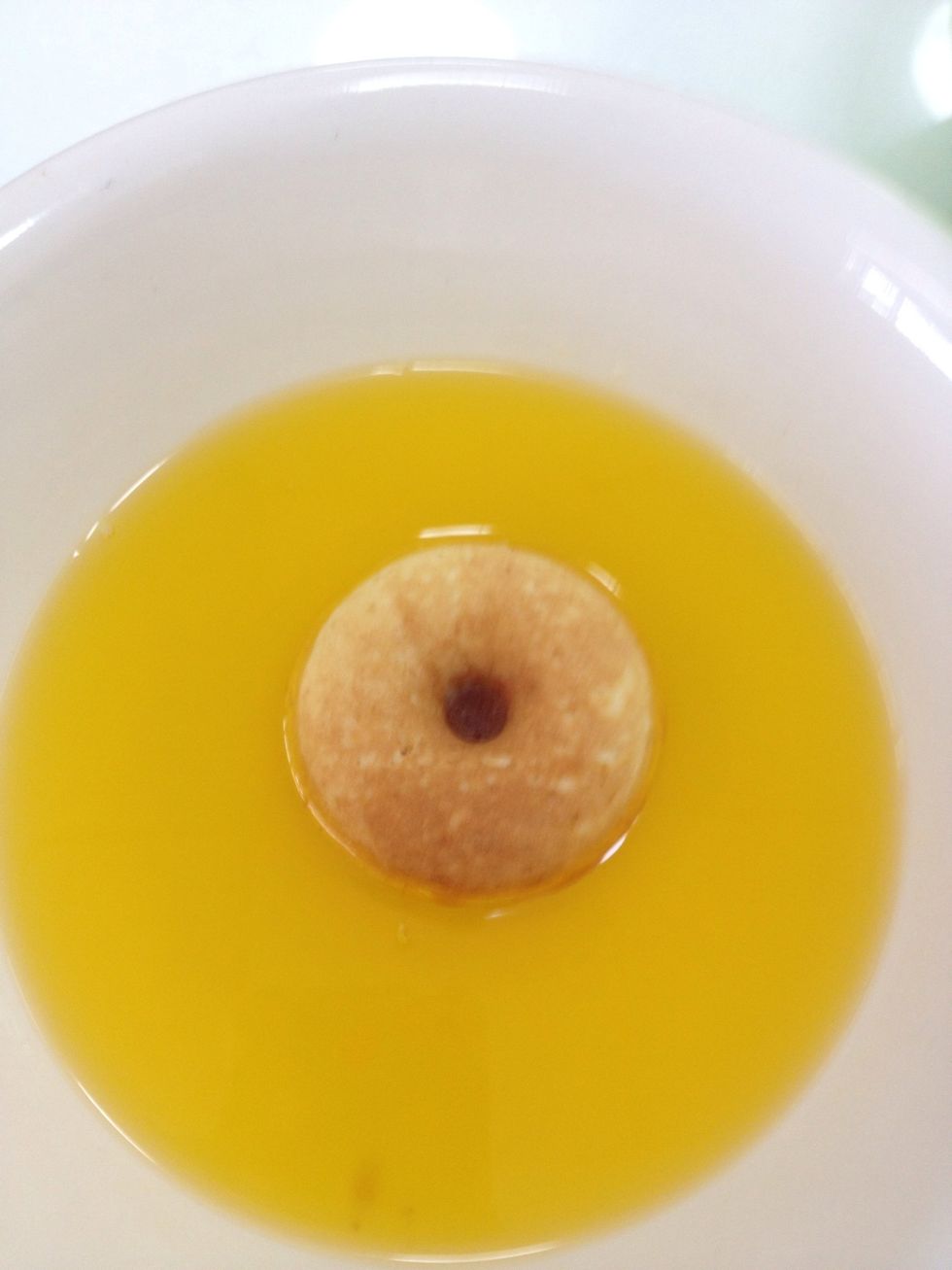 One by one, dip each doughnut in the melted butter.