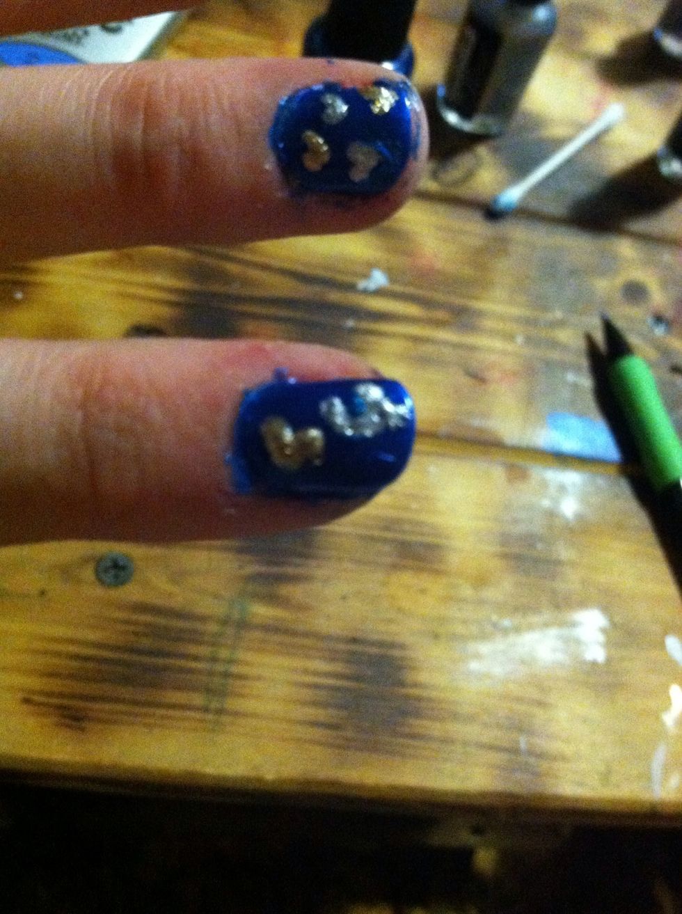 One index finger, paint a large heart in gold and then a U in silver.