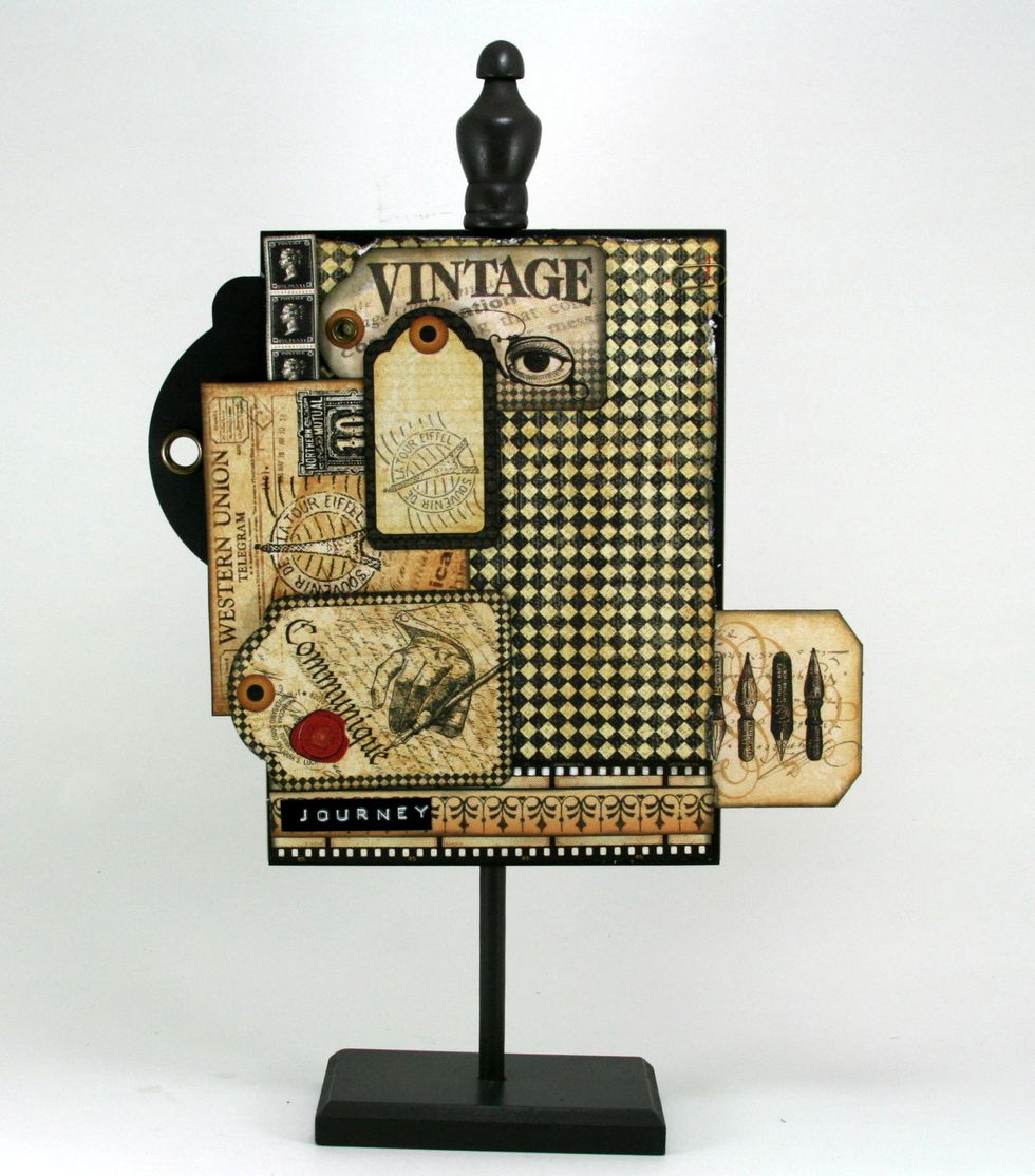 One more tag layered over postcard and vintage tag. There's also a Journey label added that was created with black tape and the Dymo Label Maker.