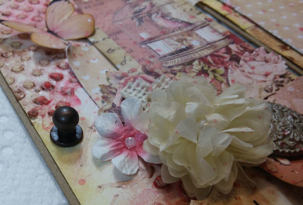 One more thing before I flip it over...I've punched a hole and put a little piece of metal hardware on he left side of the first tag. Later I'll use this to help close the album!