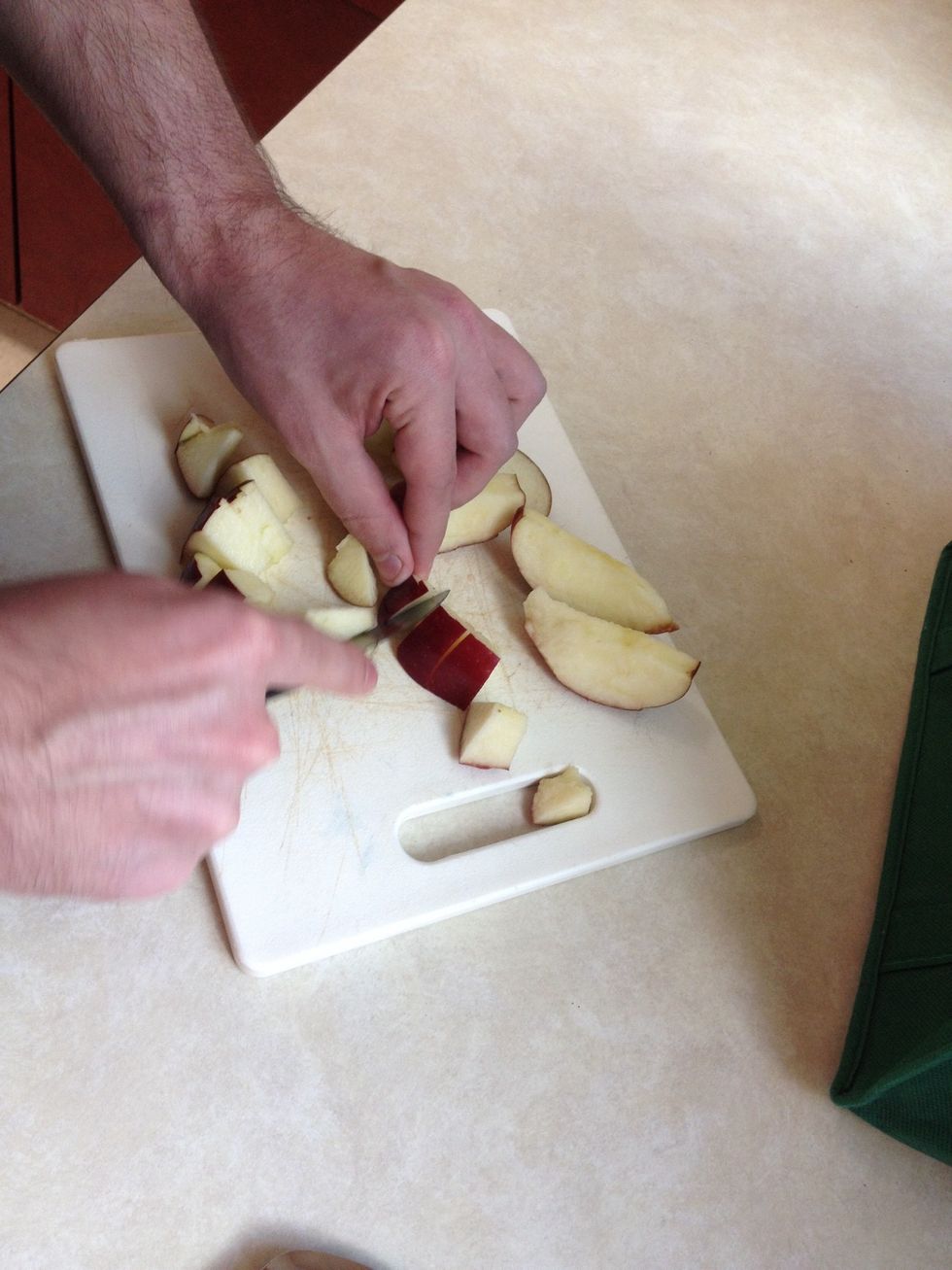 One the apple is cut apart, continue to cut it into smaller bite size pieces.