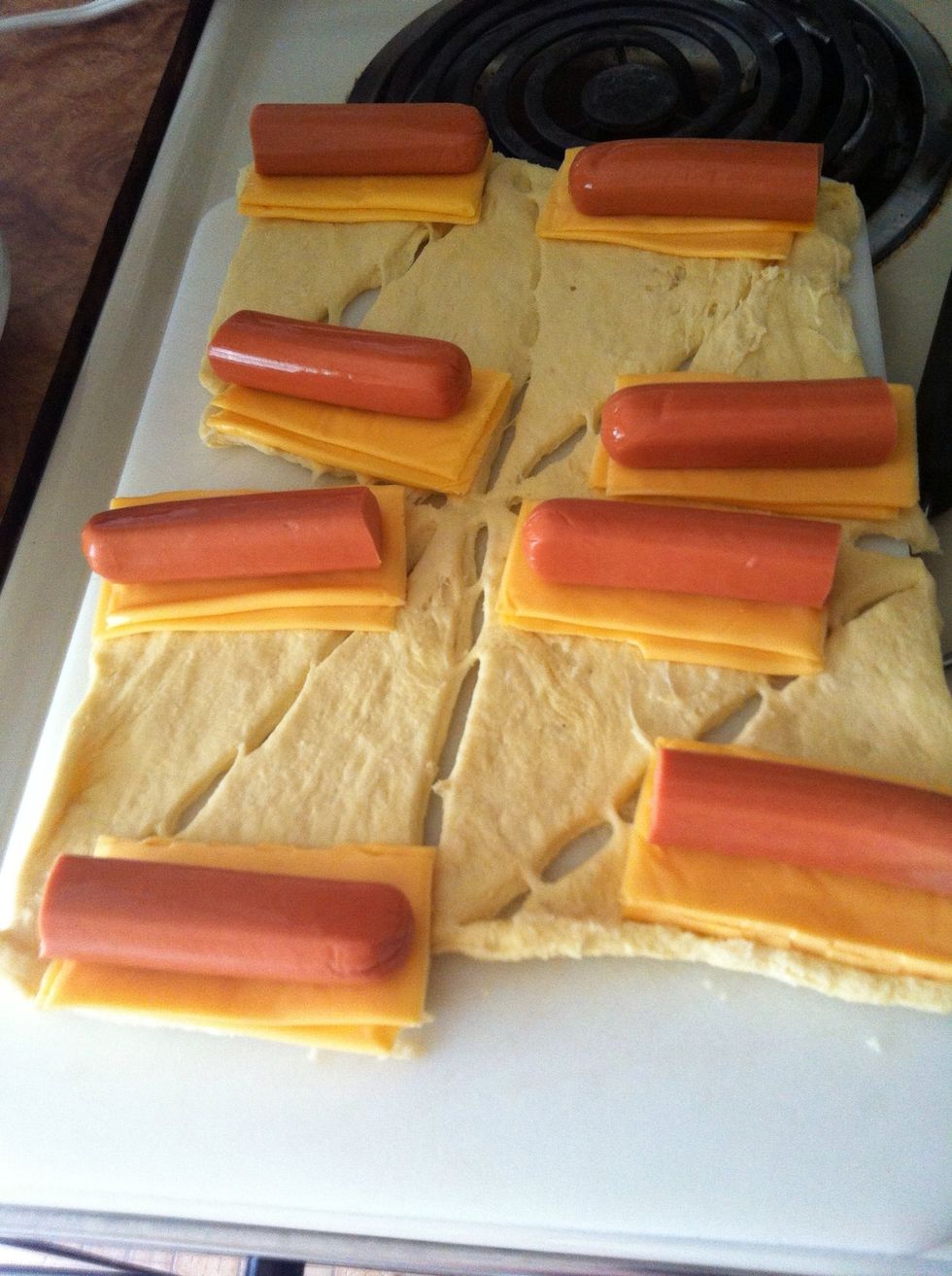 One the other eight, I used sliced cheddar cheese in halve with four long hot dogs cut in halves... (These are also known as 'Pigs in a blanket.' That's what my dad calls them.)