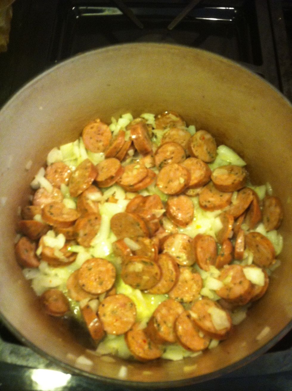 Onion and sausage only.. Add the garlic later once the onions have caramelized or they will burn