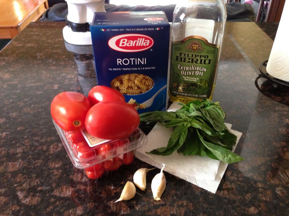 Only five ingredients are needed for this dish! You'll need fresh basil, garlic, olive oil, your pasta of choice, and tomatoes. (I used the cherry and Roma varieties, but any tomatoes will work well)