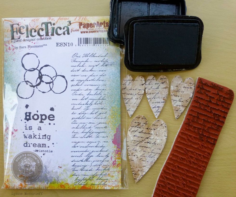 Onto each of the hearts, stamp script, with Staz-on Jet ink. The larger heart will be covered with the lace rose trim but it is a nice touch to include stamping on this heart also.