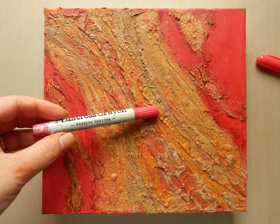 Onto the uncoloured areas of the canvas blend in a little of the Festive Berries Distress Crayon, blending over the edges of the embossing.