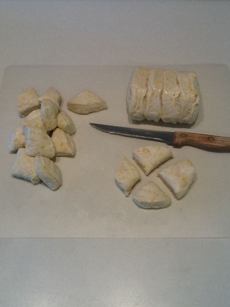 Open can of biscuits and cut into fourths.