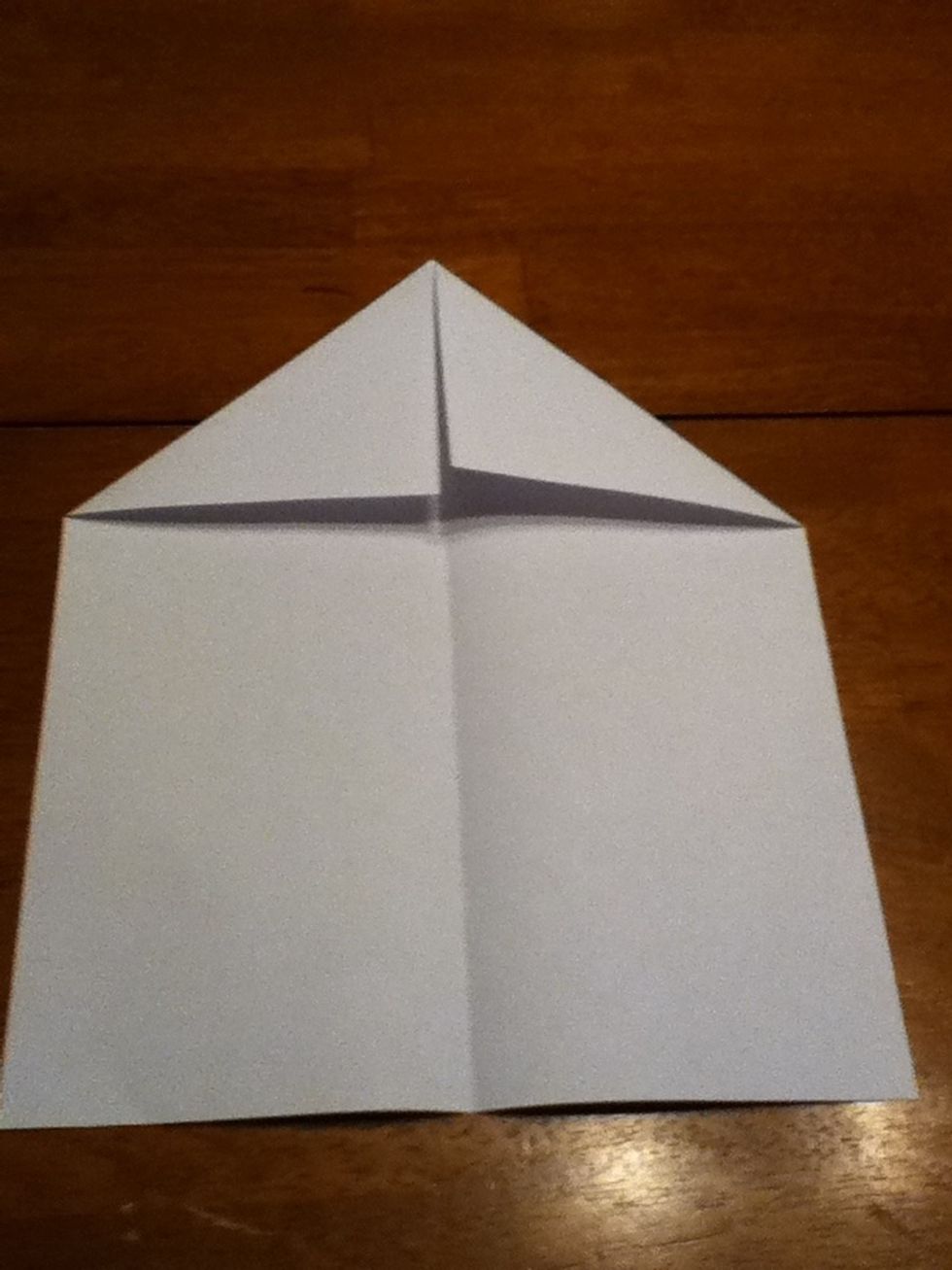 Open it up and fold the upper corners to the center crease.