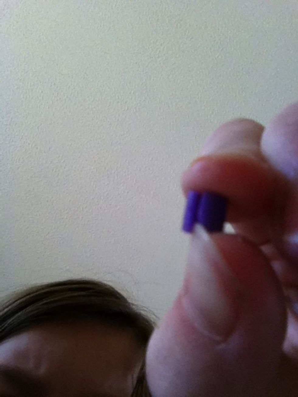 Open it up with your fingers and clip it on to the headphones.