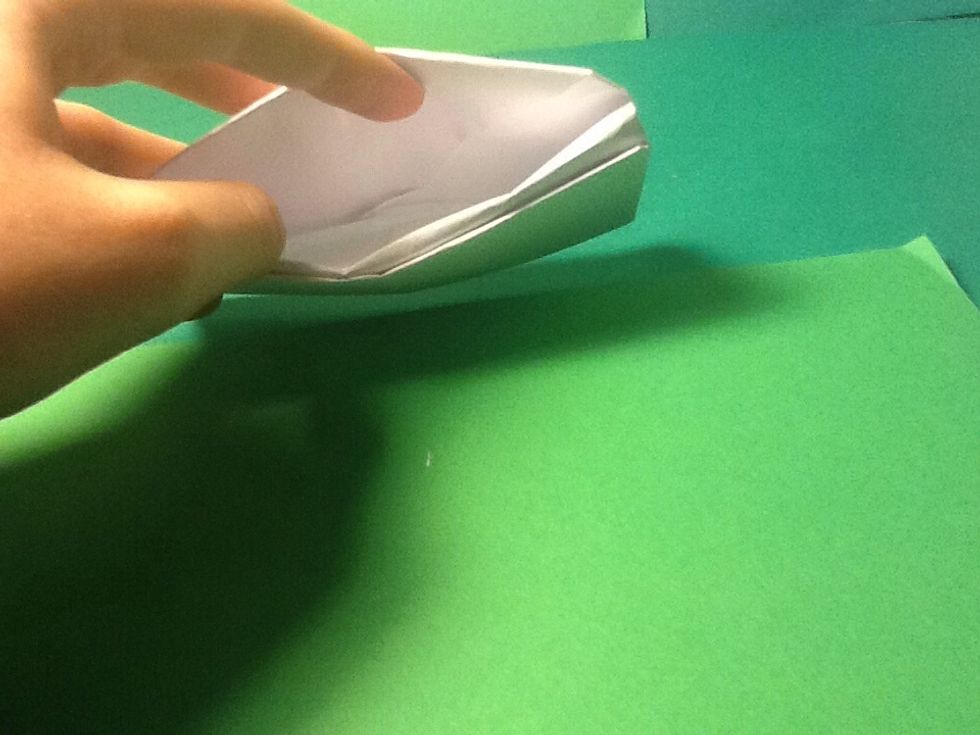 Open one of the slits and take the paper corner..