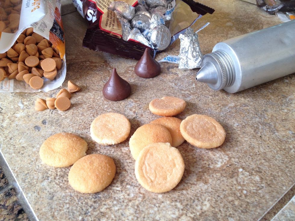 Open packages and unwrap chocolate kisses.