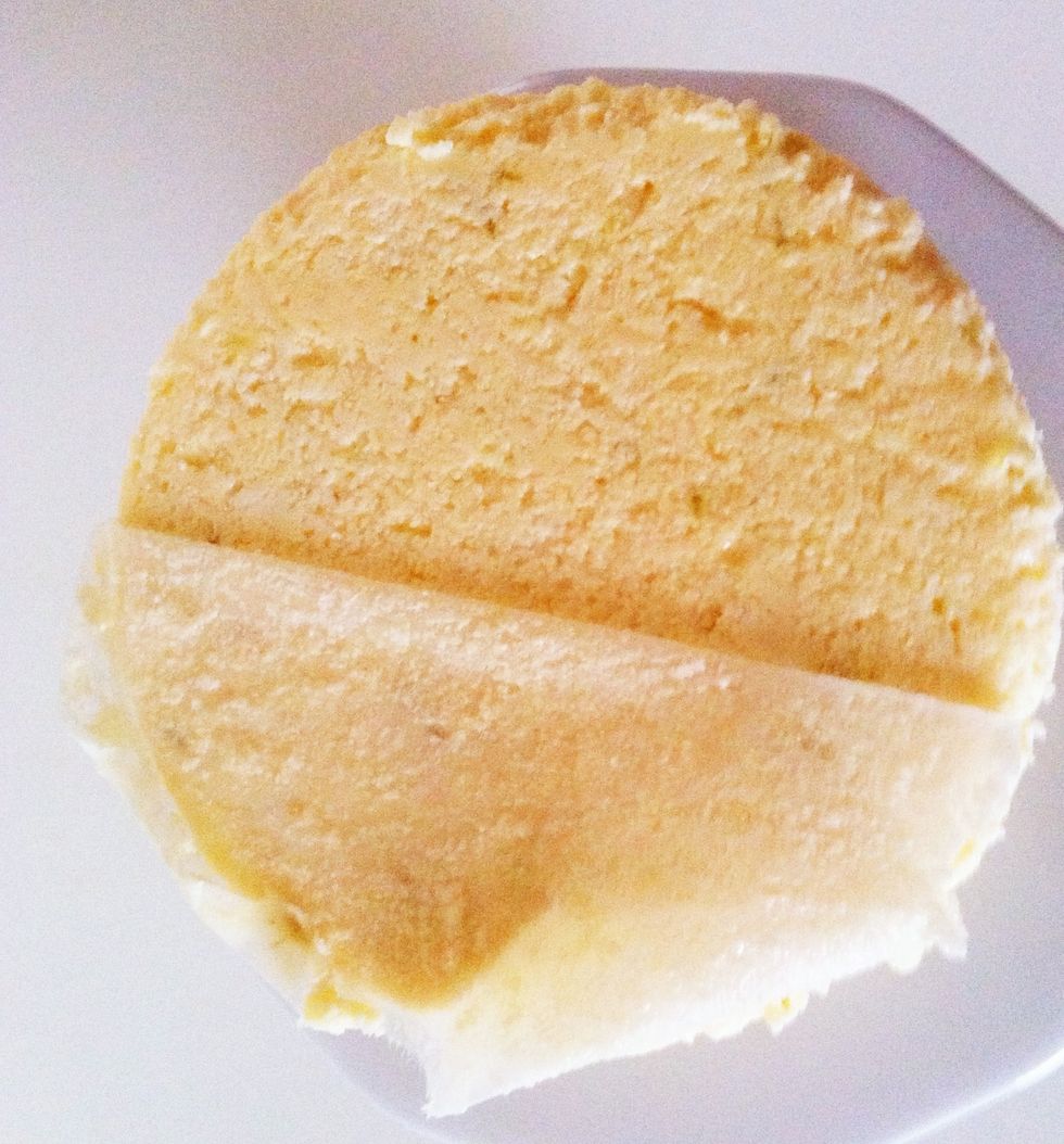 Open pan and remove the circle part. Gently run knife under cake. Place a plate on top of cake and flip. Remove paper from the bottom of the cake. Flip again. Pat the top dry with a paper towel.