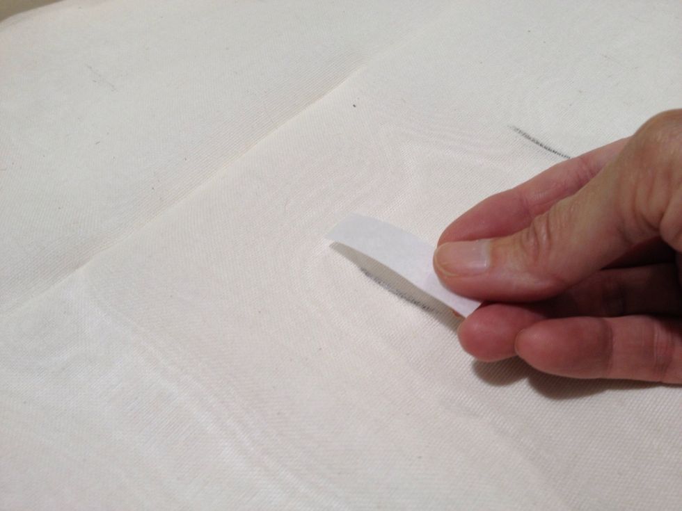 Open the 8-1/2" fold and place the cut pieces of Steam-a-Seam on the backside of the marked buttonholes. The fabric is sheer, so you should be able the see the markings through the fabric.