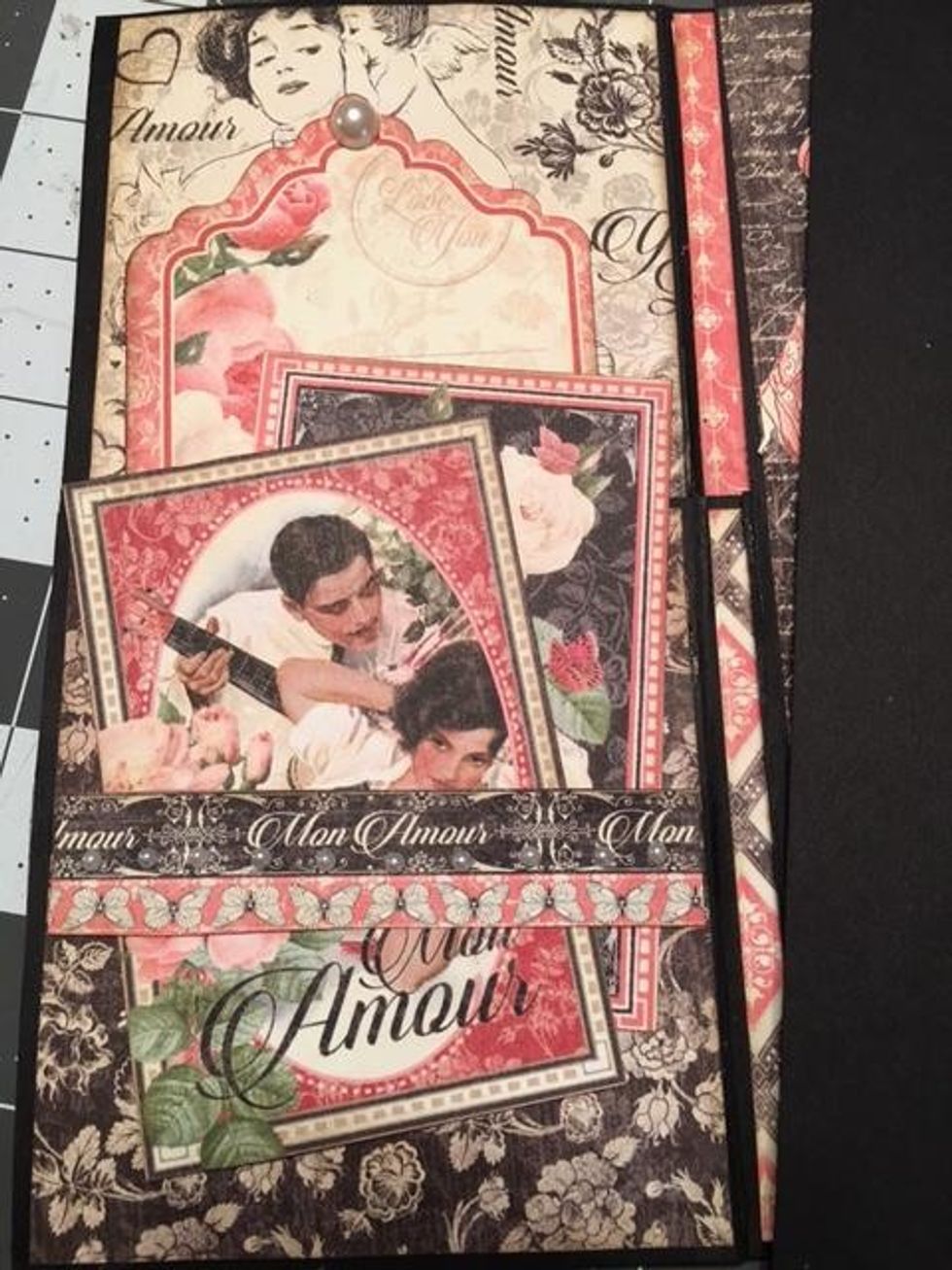 Open the booklet and decorate the first section.  Add a paper belly band cut from a border on the One & Only 8x8 sheet. Glue on the left and right ends only so you can slide two cut a parts underneath