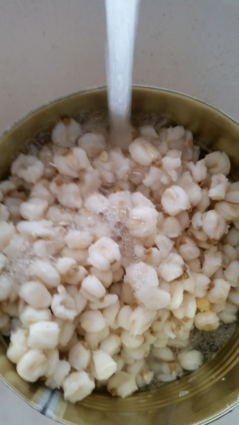 Open the can and drain out the liquid. Then fill it with water...