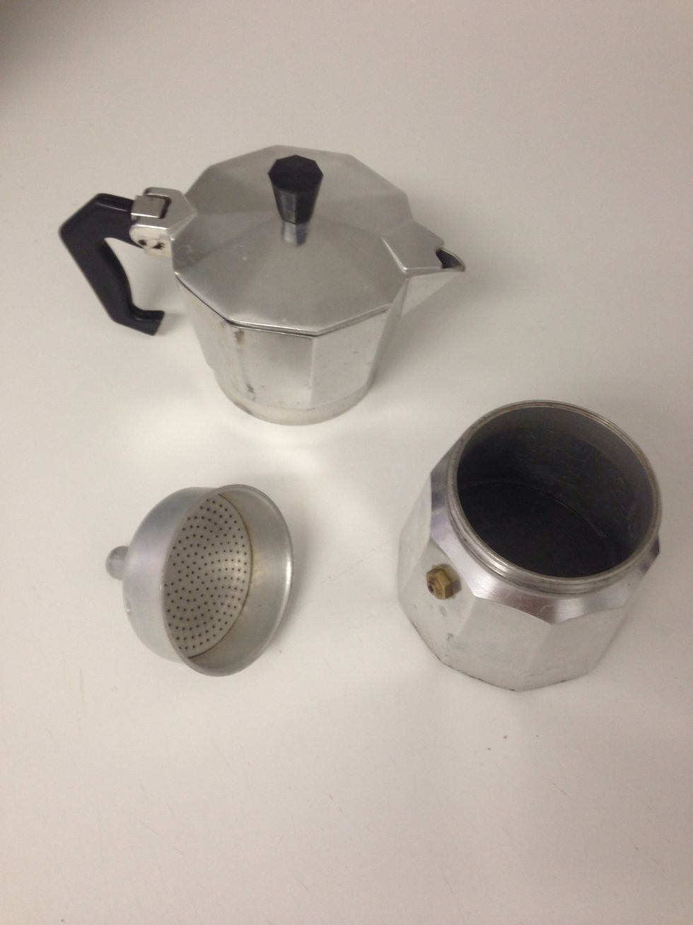 Open the coffee maker and remove the small piece in the middle.