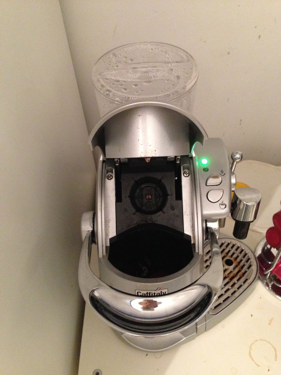 Open the coffee maker with the big hanger.