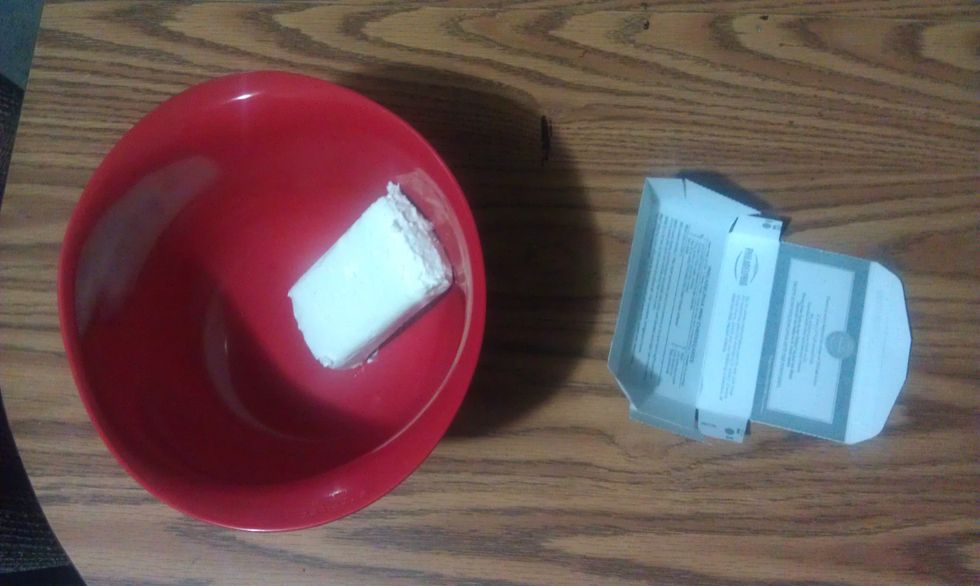 Open the cream cheese package and put it into the large bowl