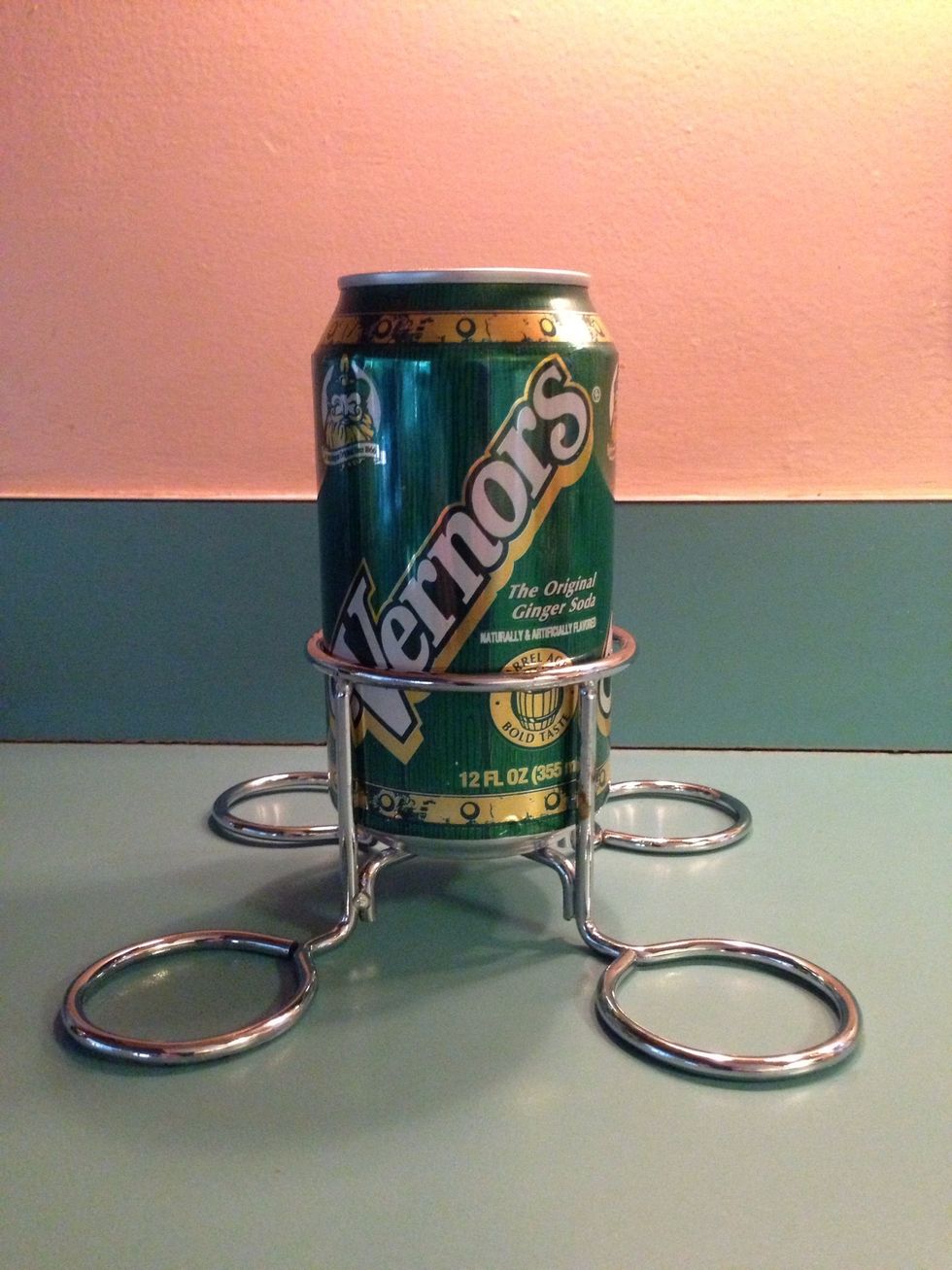 Open the ginger ale and pour out almost half of the liquid. Then place the can in the pop can holder.