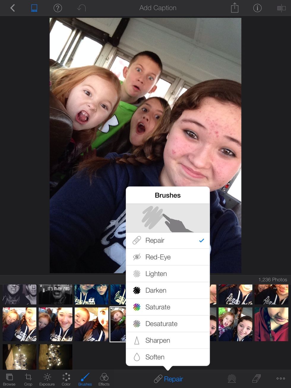 Open the iPhoto app, go to camera roll, tap the picture. Then go to brushes and choose repair.