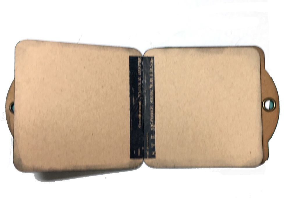 Open the mini to the center and place a 3 7/8" piece of washi tape over the stitched seam.