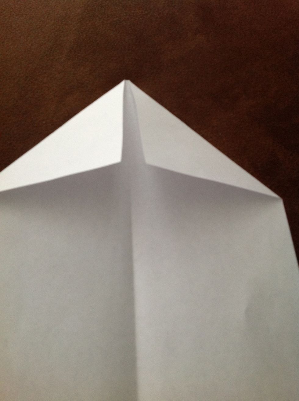 Open the paper airplane up. Fold each corner in towards the center to the point where the inside edges are even with the centerline crease.