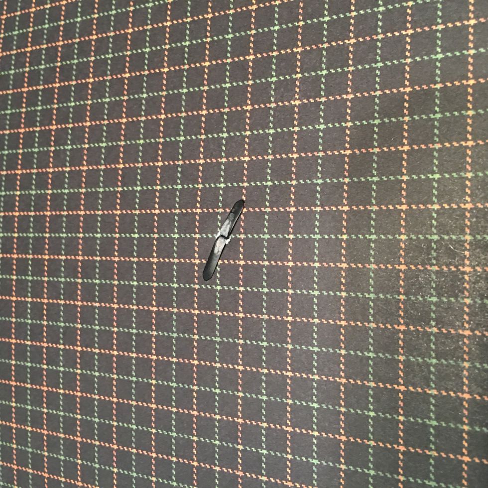 Open the prongs on the back side of the patterned paper.