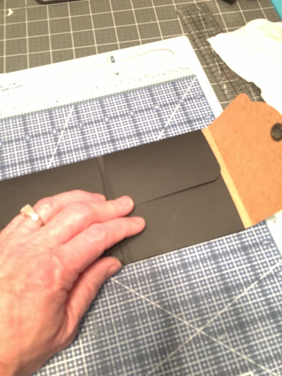 Open the tag back out and close the inner flaps of the album. The black flaps on the right will go over the remaining part of the Kraft tag as shown in this photo.