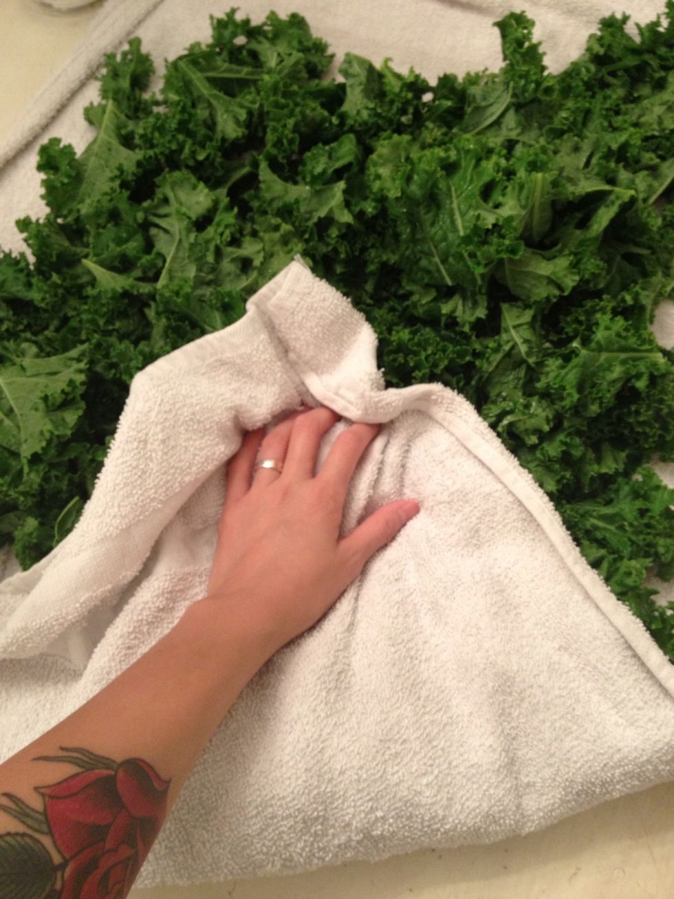 Open the towel and turn some of the leaves a bit and fold over again and blot some more.