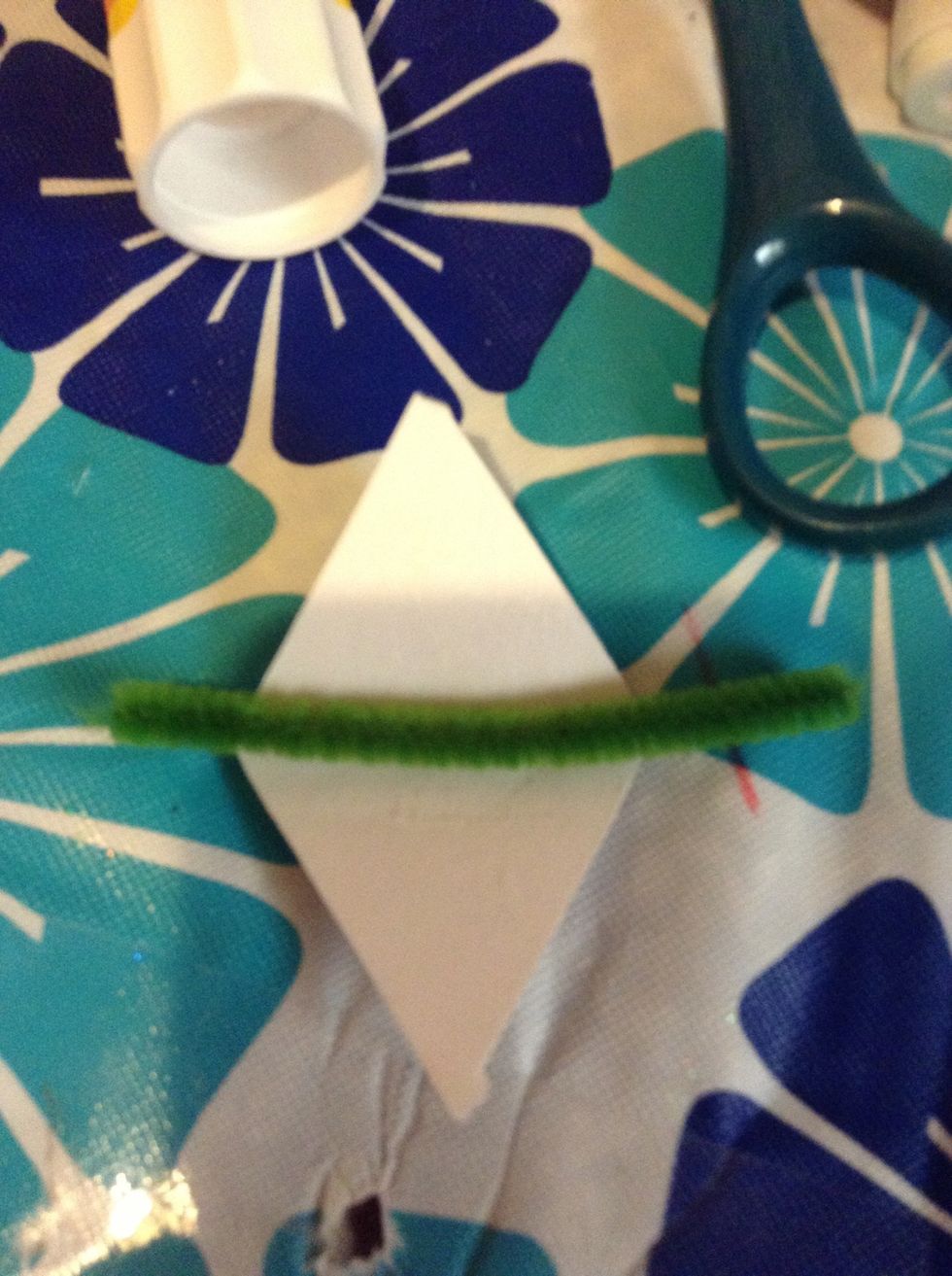 Open the triangle and glue the inside and put the pipe cleaner in!