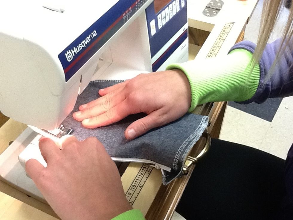 Open the zipper. From the right side of the fabric, top stitch using a 3.5 stitch length. Run the left side of the presser foot next to the fabric edge as your guideline.