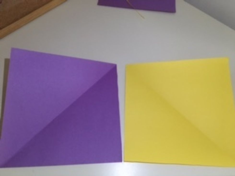 Open them up. As per the crease, you can see that the two papers are mirror images.