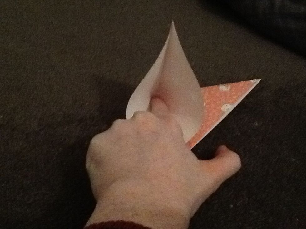 Open up one of the triangles and put your finger right into the corner