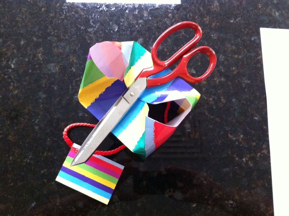 Open up the bag and fold those sides into the centre at the creases. (my scissors are there just to hold the folded sides in place).