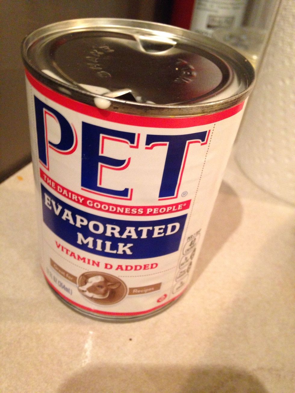 Open up the can of milk and make sure you open a hole on each side