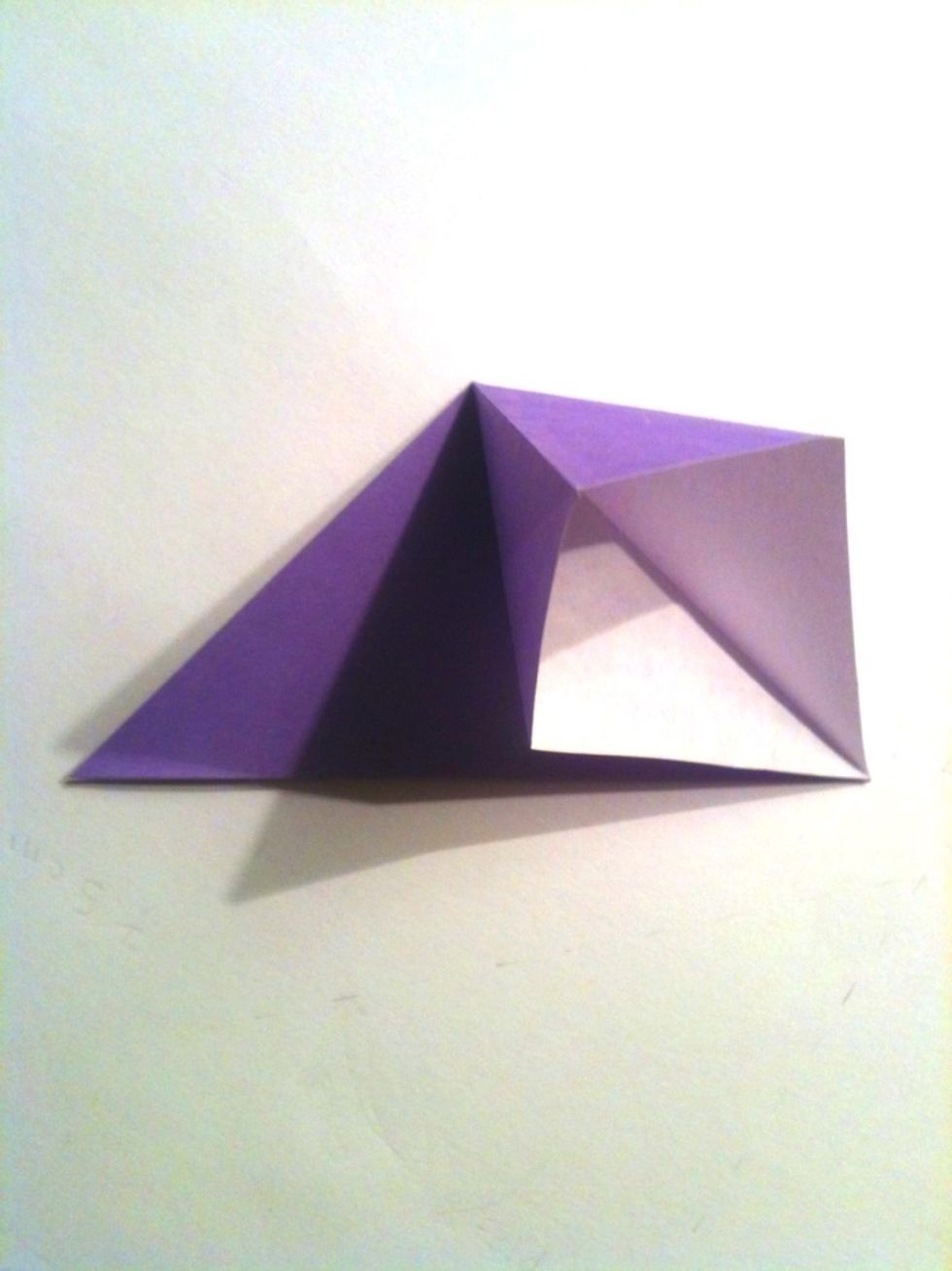 Open up the flap of paper.