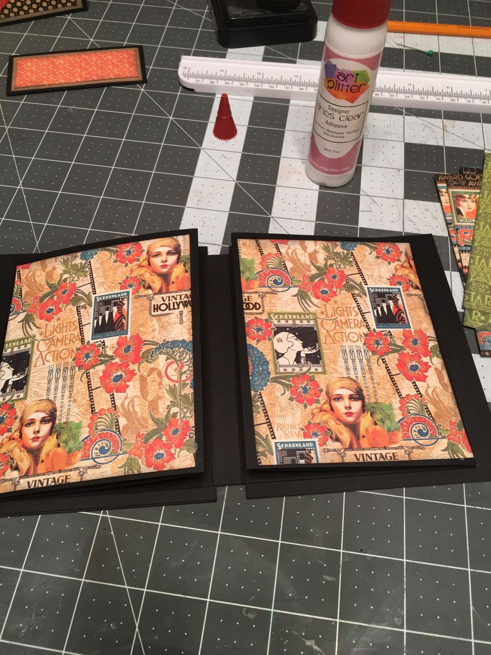 Open up your album and attach the first matching set of patterned papers to the first two pages you see. Use your preferred glue or scor-tape to attach your patterned page papers.