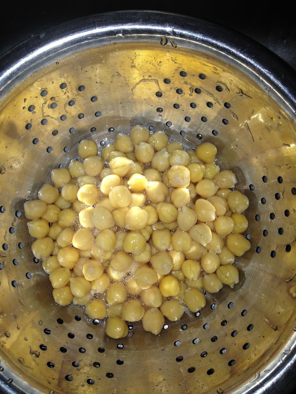 Open your can of chickpeas (garbanzos, whatever), then drain them.