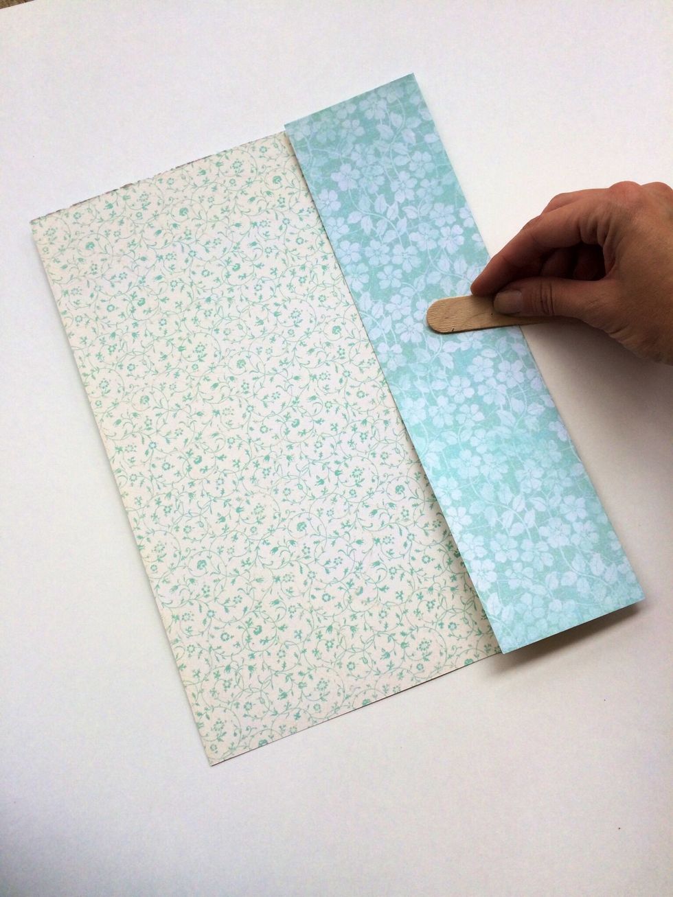 Open your paper back up. Fold one side in to meet the center crease you made. Crease your gold and then repeat with the other side.